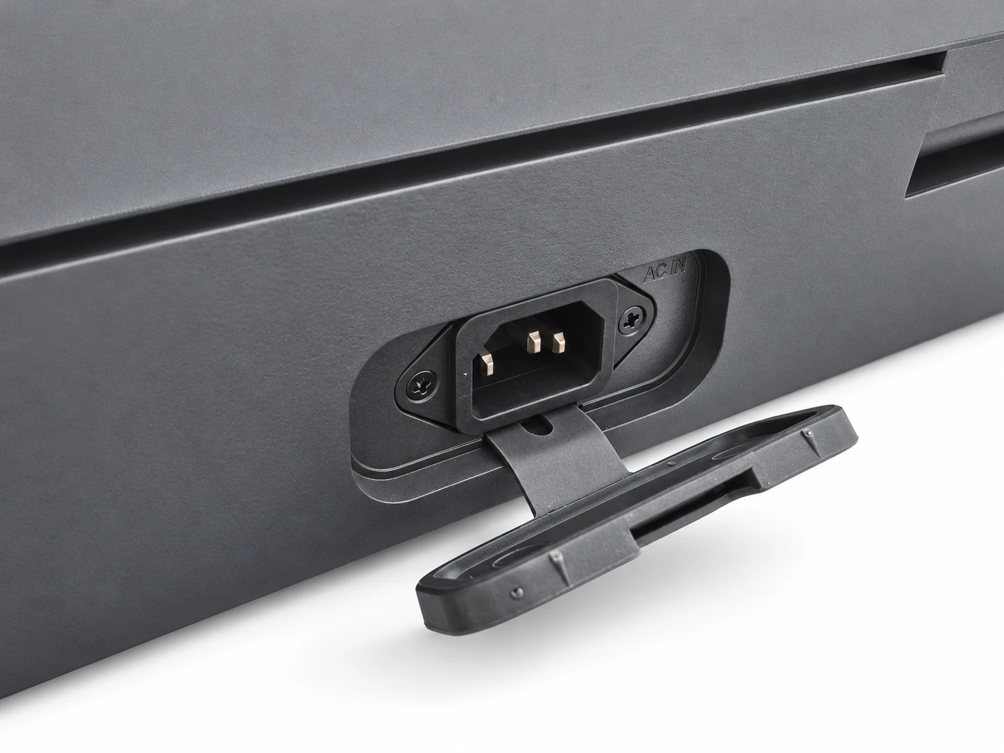The AC IN mains socket on the side of the AX-Core case